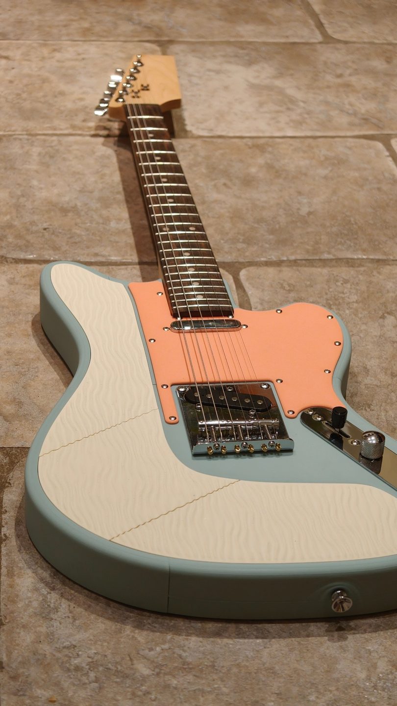 Sage body, bone Ripple guitar plates and a peach pickguard.
